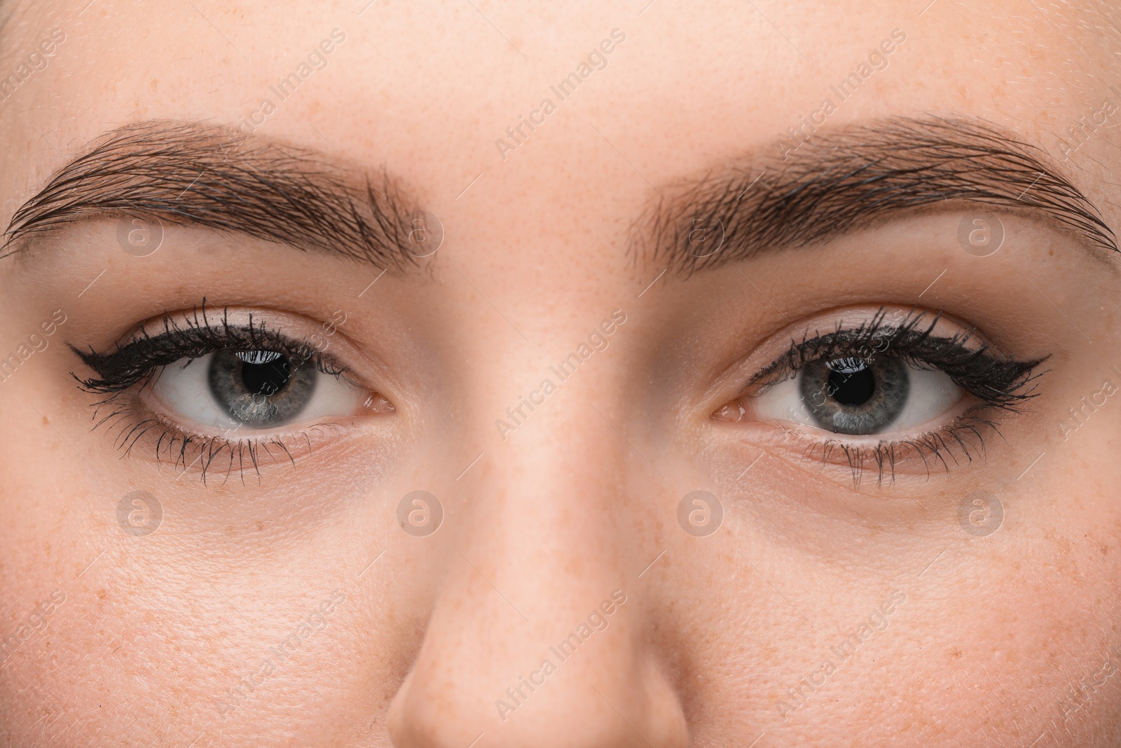 Photo of Makeup product. Woman with black eyeliner and beautiful eyebrows, closeup