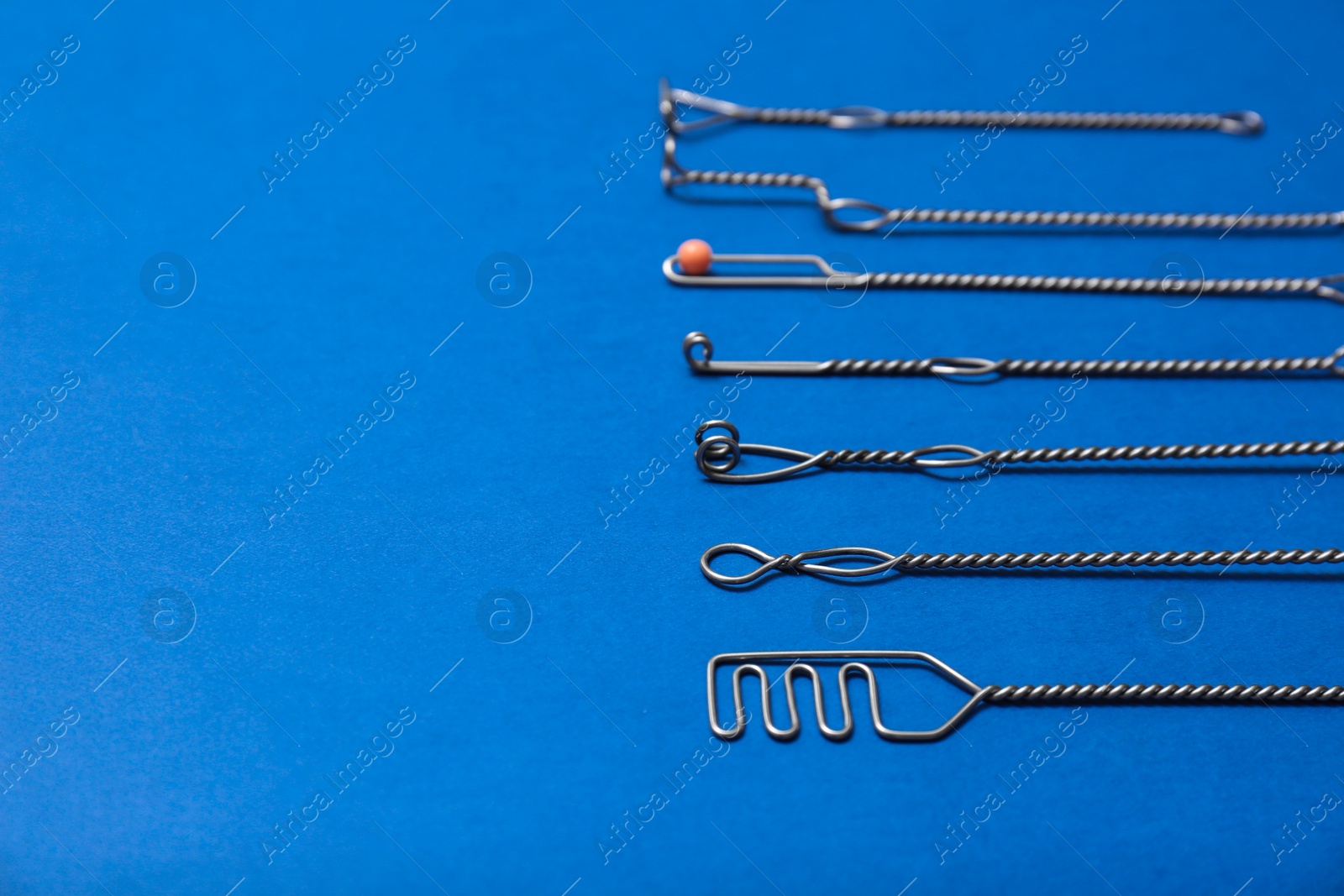 Photo of Set of logopedic probes for speech therapy on blue background. Space for text