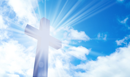 Image of Silhouette of cross against blue sky. Christian religion
