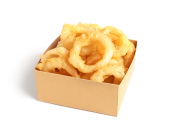 Photo of Delicious golden breaded and deep fried crispy onion rings in cardboard box on white background