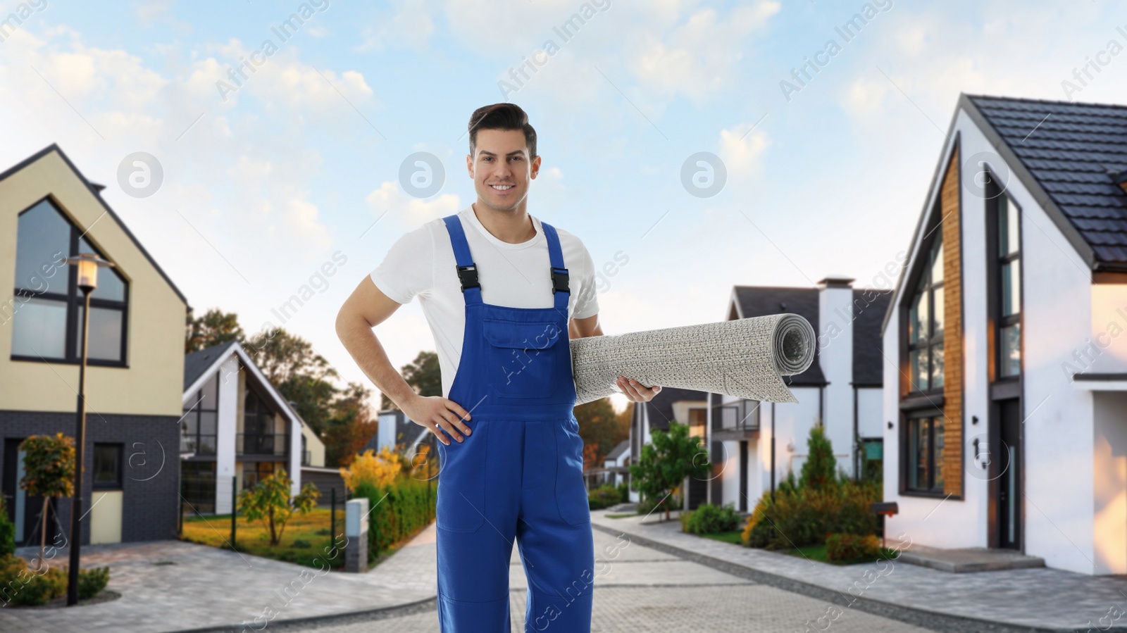 Image of Worker with rolled carpet outdoors on sunny day. Banner design