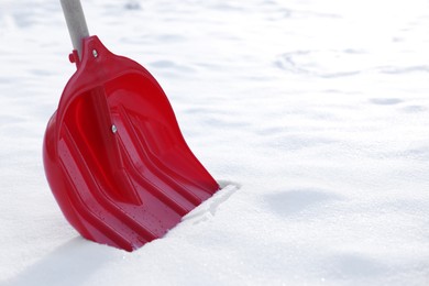 Photo of Snow shovel with wooden handle outdoors, closeup. Space for text