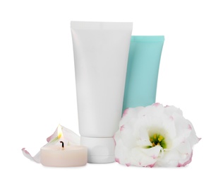 Photo of Cosmetic products and flower on white background