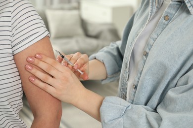 Photo of Diabetes. Woman getting insulin injection indoors, closeup