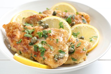 Photo of Delicious chicken piccata on white table, closeup