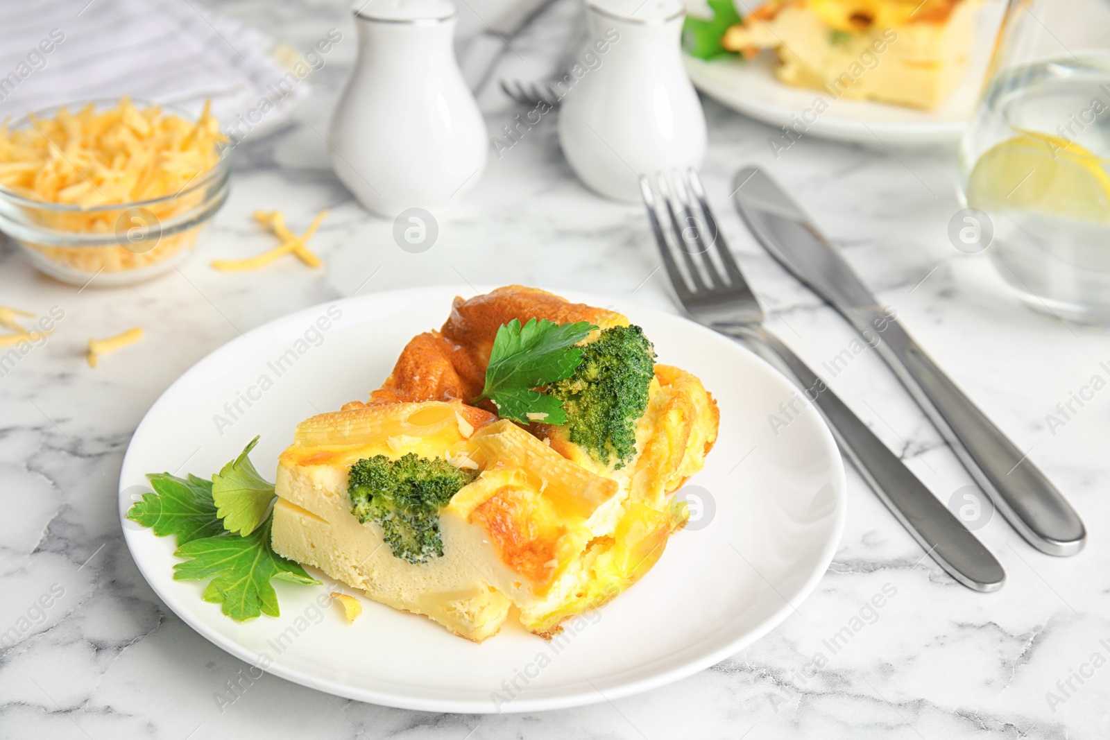 Tasty broccoli casserole served on white marble table Photo of Tasty broccoli casserole served on white marble table