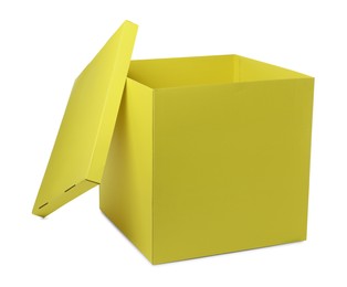 Photo of Yellow gift box with cap isolated on white