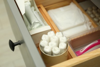 Photo of Storage of different feminine hygiene products in drawer, closeup