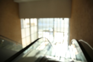 Photo of Blurred view of modern escalator in shopping mall