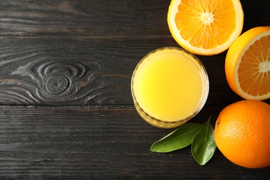 Photo of Glass with orange juice and fresh fruit on wooden background, flat lay with space for text