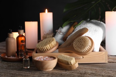Photo of Composition with different spa products and burning candles on wooden table