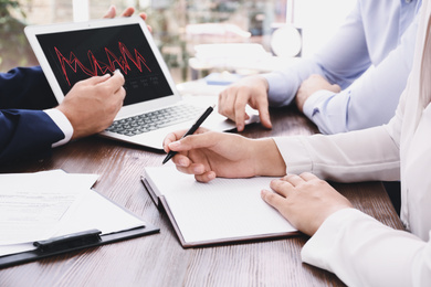 Image of Brokers working at table in office, closeup. Forex trading