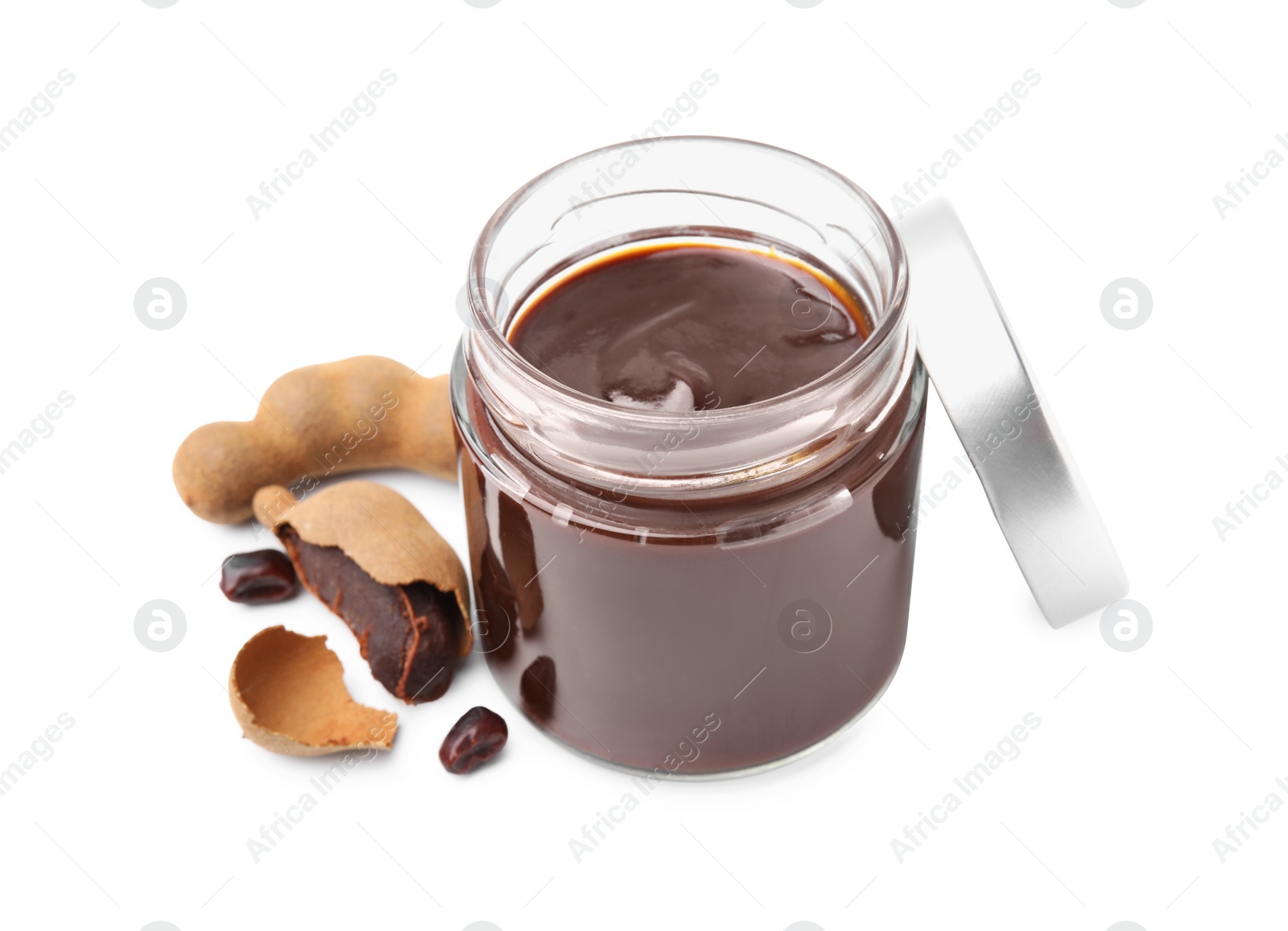 Jar of tasty tamarind sauce and fresh pods isolated on white Photo of Jar of tasty tamarind sauce and fresh pods isolated on white