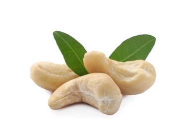 Photo of Tasty organic cashew nuts and green leaves isolated on white, closeup