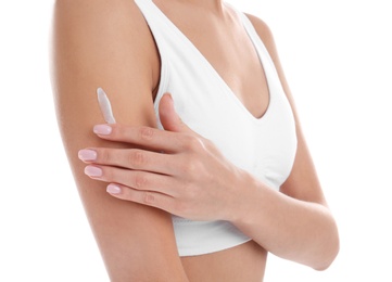 Photo of Young woman applying cream on white background, closeup. Beauty and body care