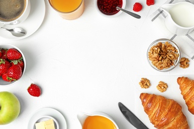 Photo of Frame made with tasty meal for breakfast on white table, flat lay. Space for text