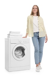 Photo of Beautiful young woman near washing machine with laundry on white background