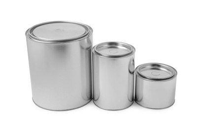 Photo of New metal paint cans on white background