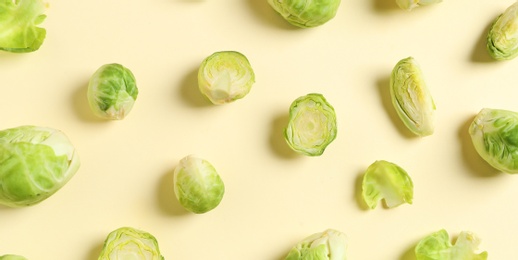 Photo of Fresh Brussels sprouts on color background, flat lay