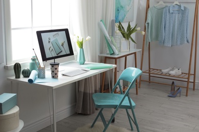 Photo of Stylish workplace interior with modern computer on desk