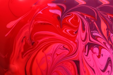 Photo of Mixed different color nail polishes as background, closeup