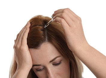 Photo of Woman applying oil onto hair on white background, closeup. Baldness problem