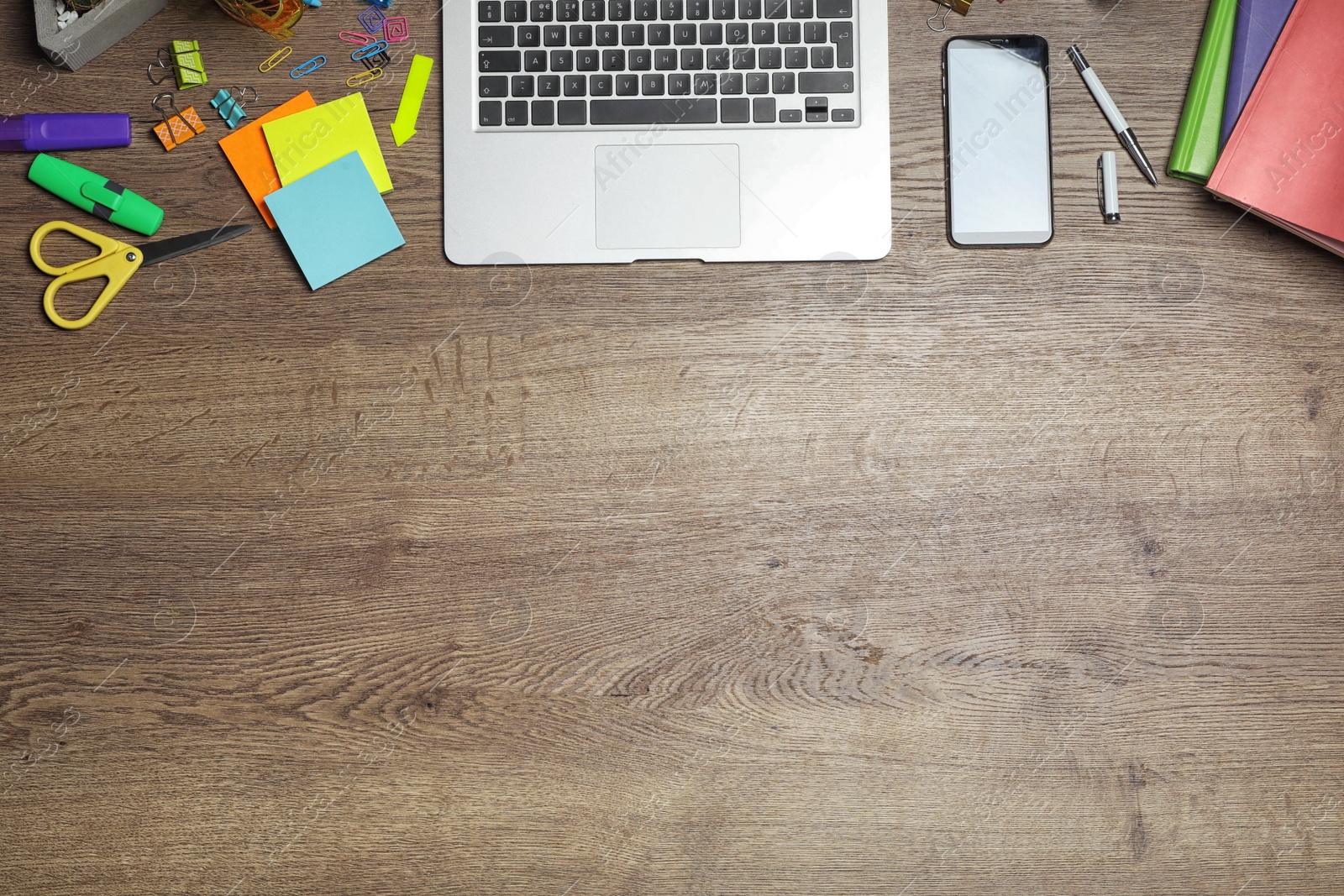 Photo of Flat lay composition with laptop, smartphone and stationery on wooden table, space for text. Designer's workplace