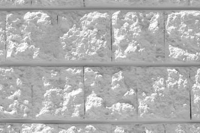 Photo of White rough stone wall as background, closeup