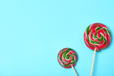 Photo of Tasty candies and space for text on color background, top view