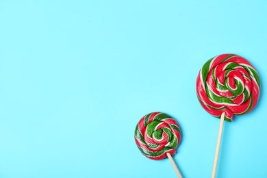 Tasty candies and space for text on color background, top view