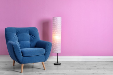 Photo of Comfortable armchair in stylish living room interior with space for text