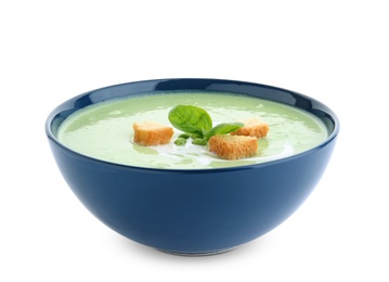 Photo of Green pea soup with croutons in bowl on white background