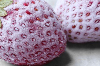 Photo of Frozen ripe strawberries on light table, closeup view