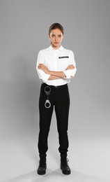Photo of Female security guard in uniform on grey background