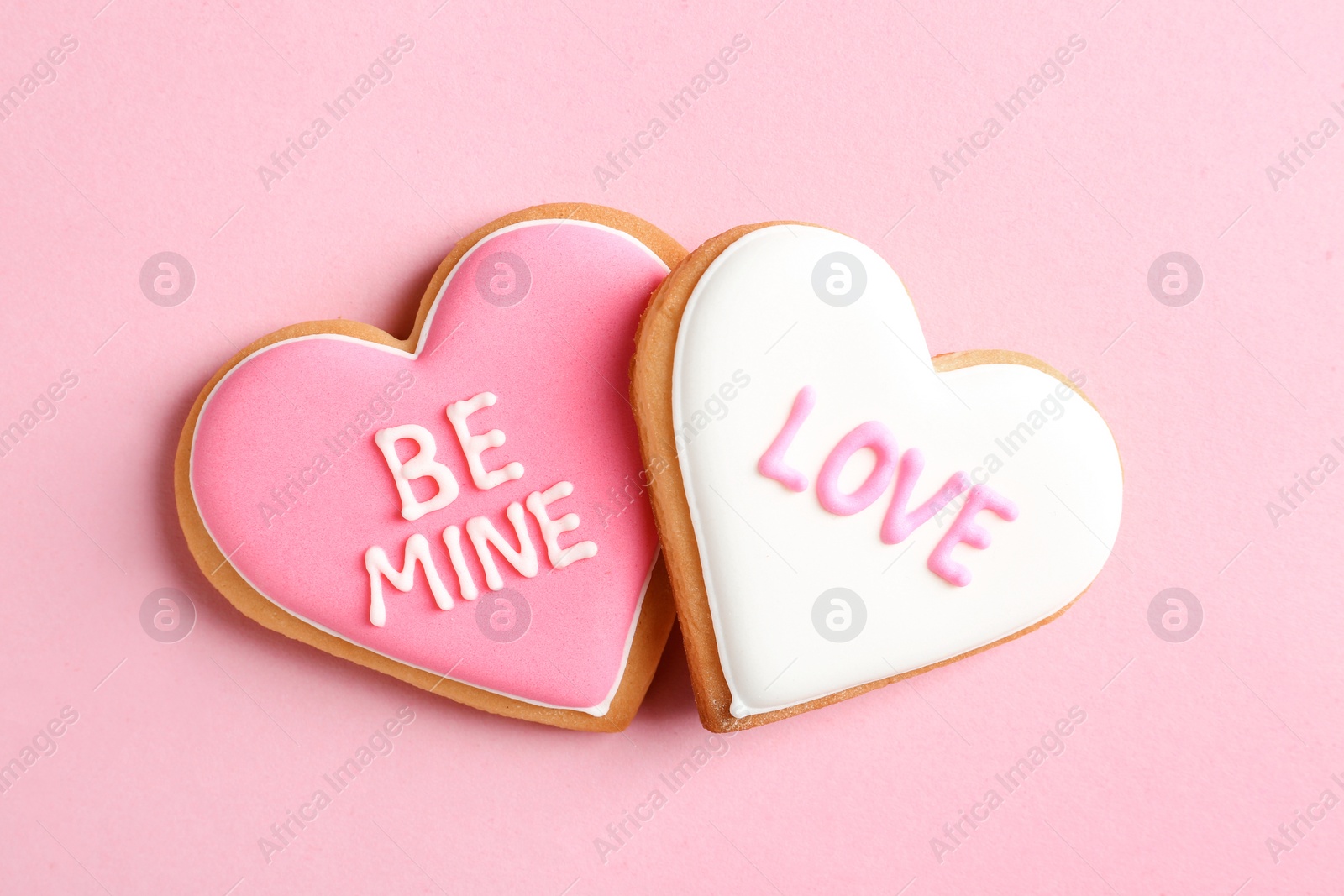 Photo of Decorated heart shaped cookies on color background, top view. Valentine's day treat