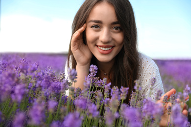 Photo of Young woman in lavender field on summer day