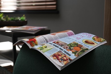 Photo of Different lifestyle magazines on sofa at home