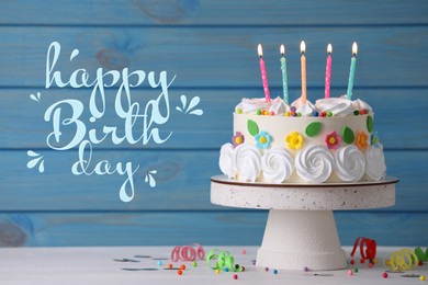 Image of Happy Birthday! Delicious cake and party decor on white wooden table