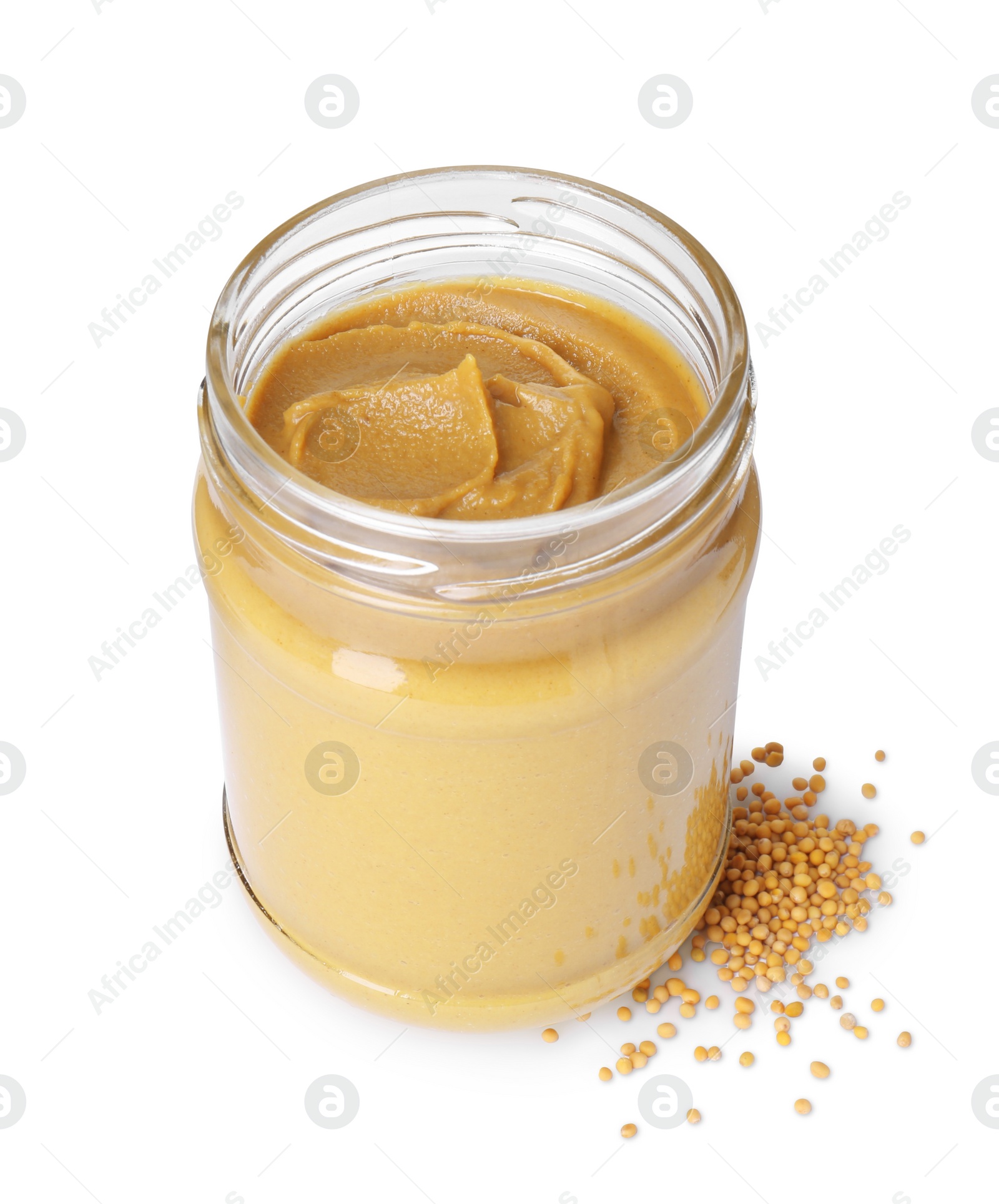 Photo of Glass jar of tasty mustard sauce and dry seeds isolated on white