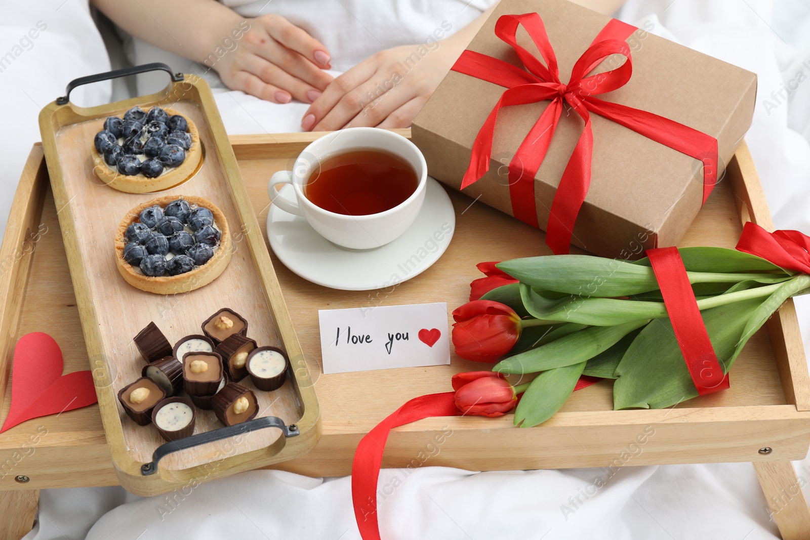 Photo of Woman having breakfast in bed at home, closeup