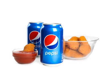 MYKOLAIV, UKRAINE - FEBRUARY 15, 2021: Cans of Pepsi and snack on white background