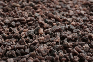 Photo of Pile of black salt as background, closeup