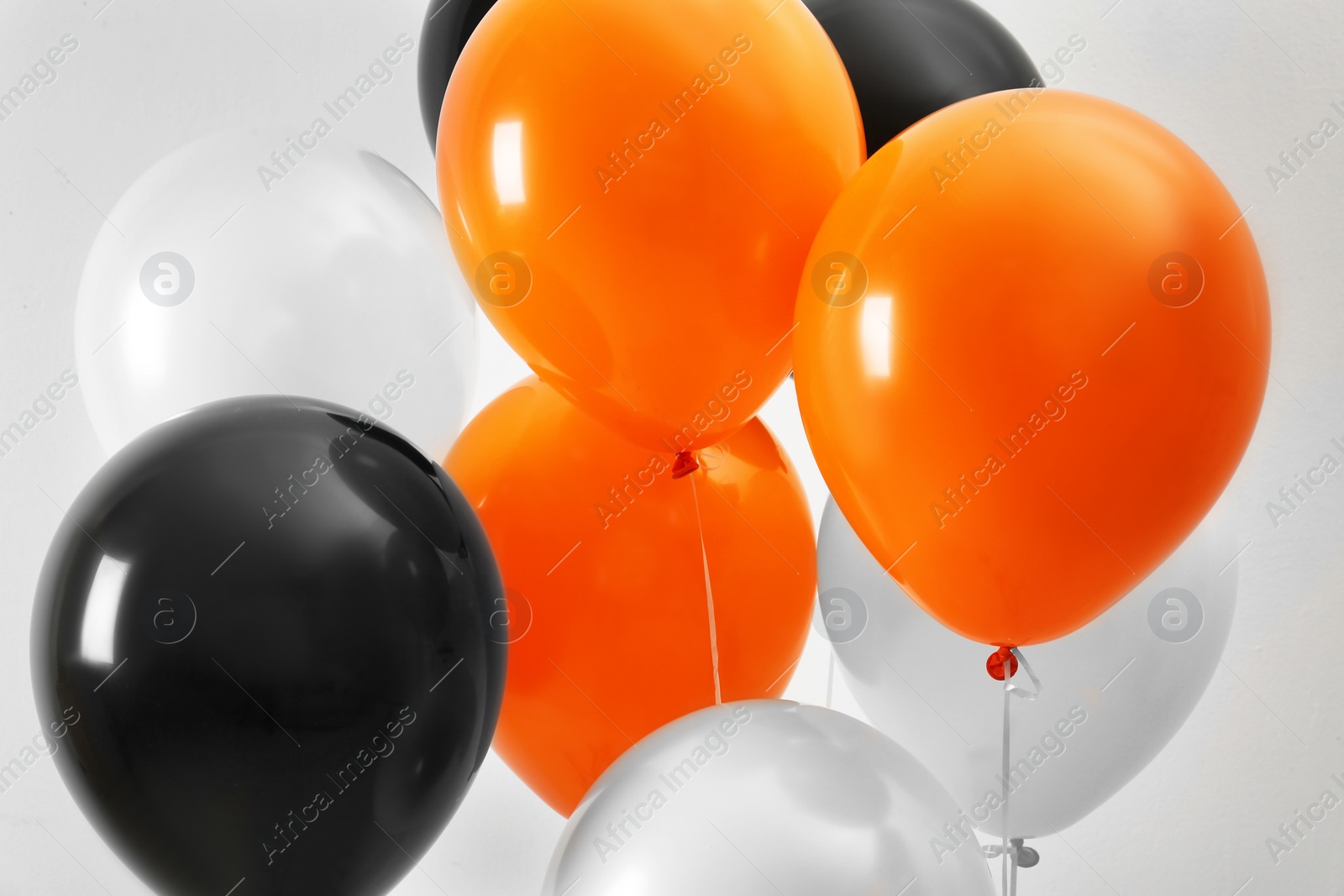 Photo of Colorful balloons on light background. Halloween party