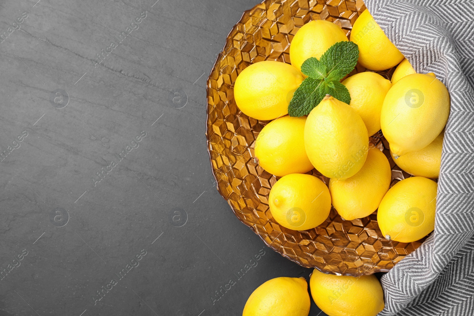 Photo of Fresh ripe lemons on grey table, flat lay. Space for text