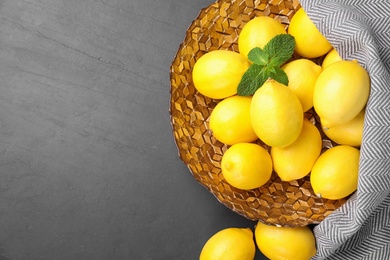 Fresh ripe lemons on grey table, flat lay. Space for text