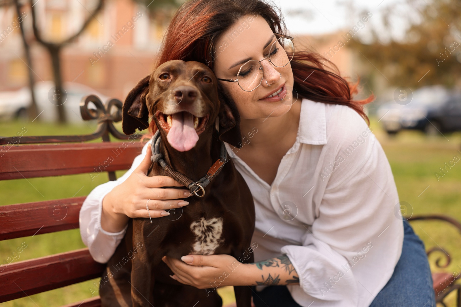 Photo of Woman with her cute German Shorthaired Pointer dog outdoors