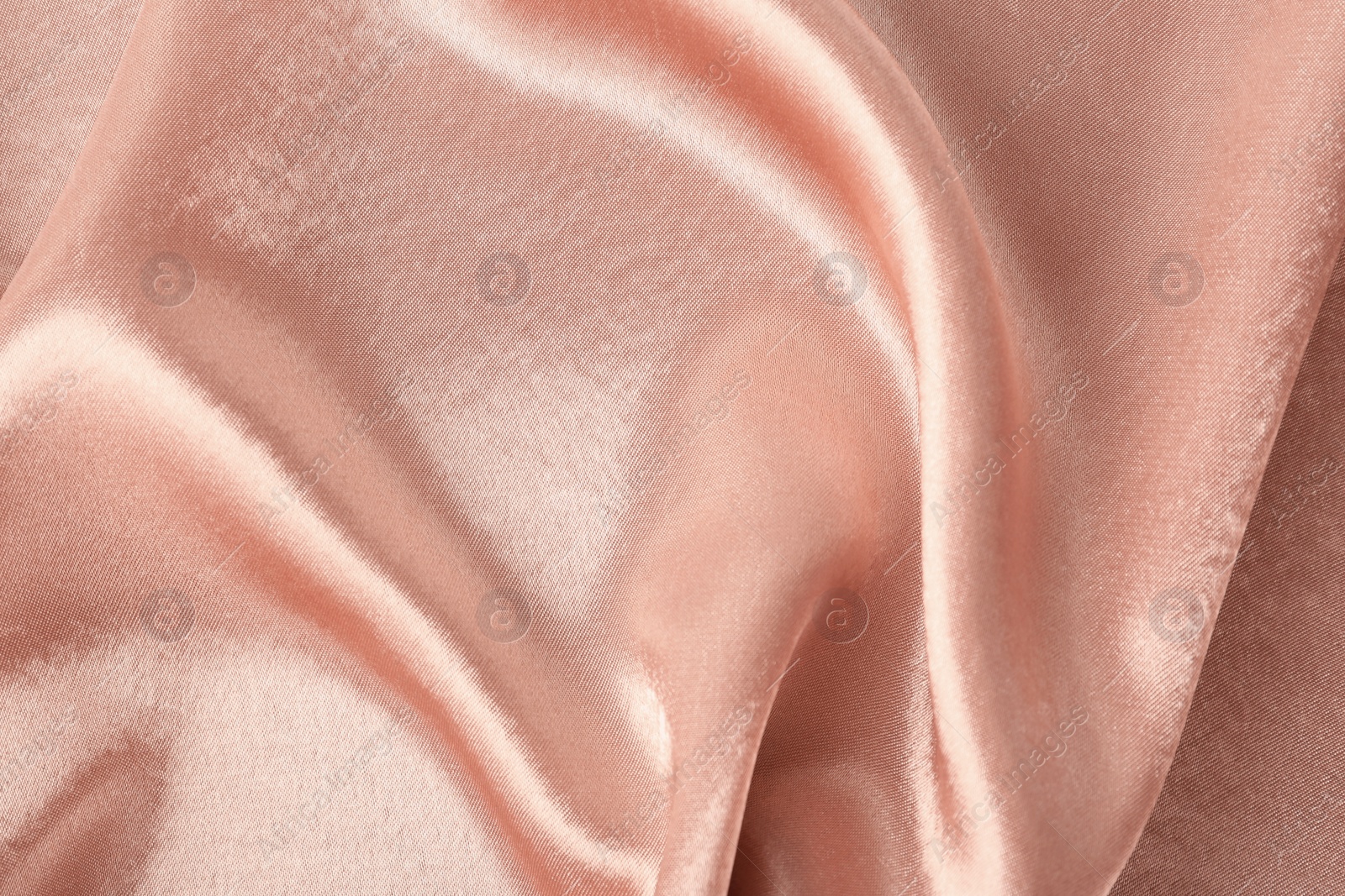 Photo of Texture of rose gold silk as background, closeup