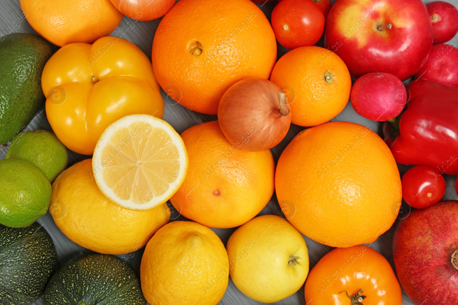 Photo of Rainbow collection of ripe fruits and vegetables as background, top view