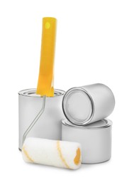 Photo of Closed blank cans of paint and roller brush on white background