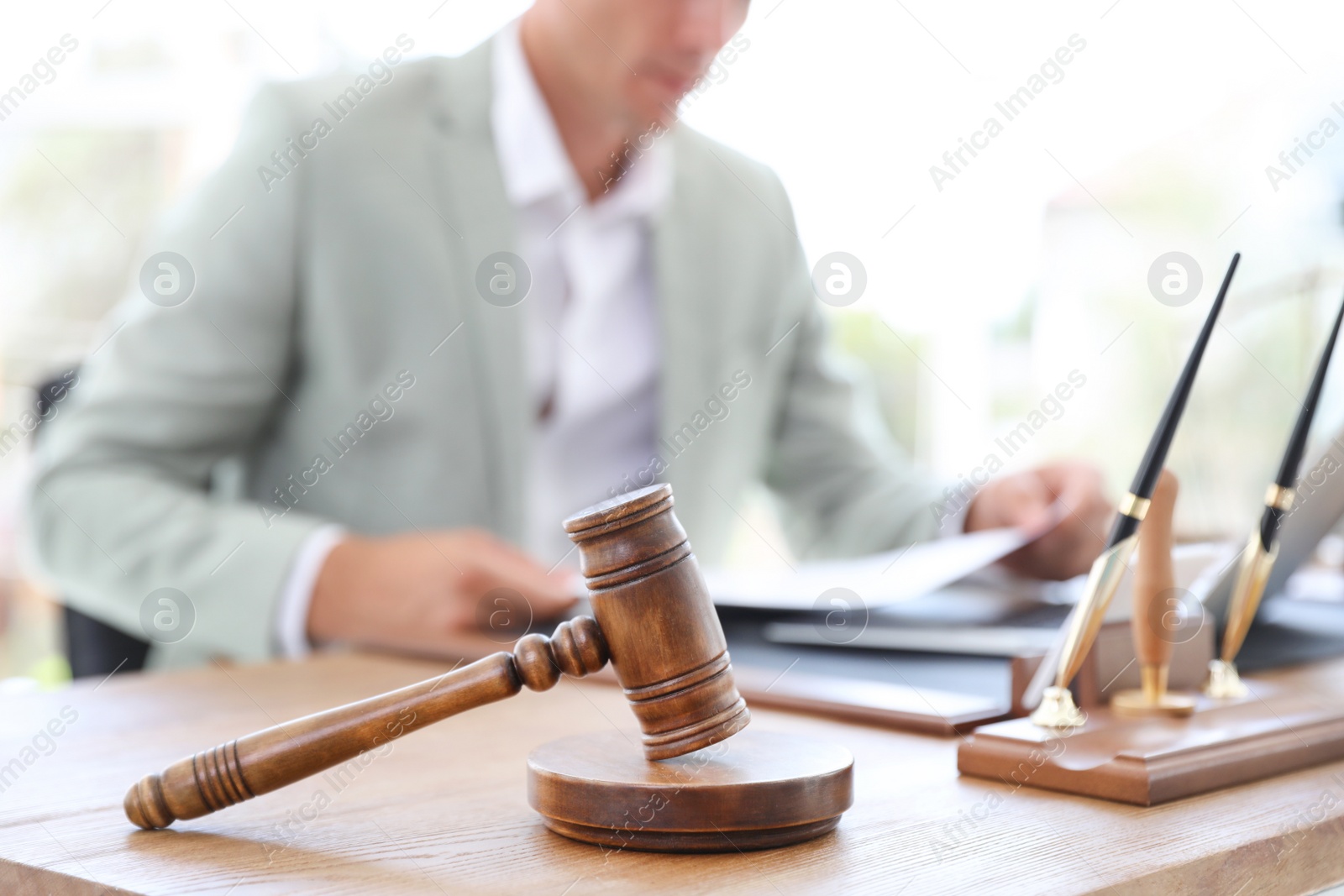 Photo of Wooden gavel and blurred notary on background